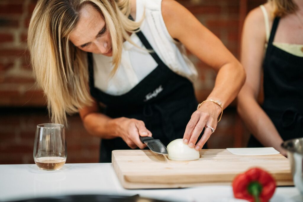Woman chopping onions at Boulder Food Hall