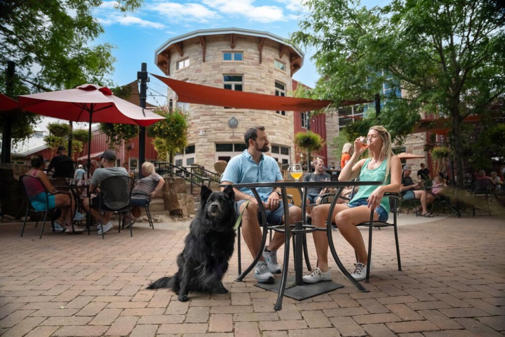 People drinking outside O'Dell Brewing with dog