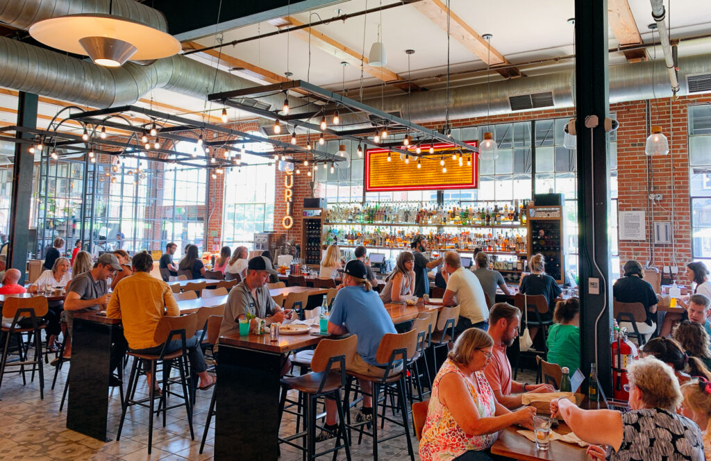 People in Denver Central Market eating and talking