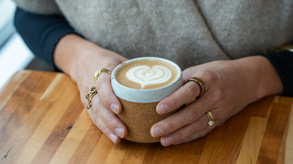 Hands at Hearth holding a pretty latte